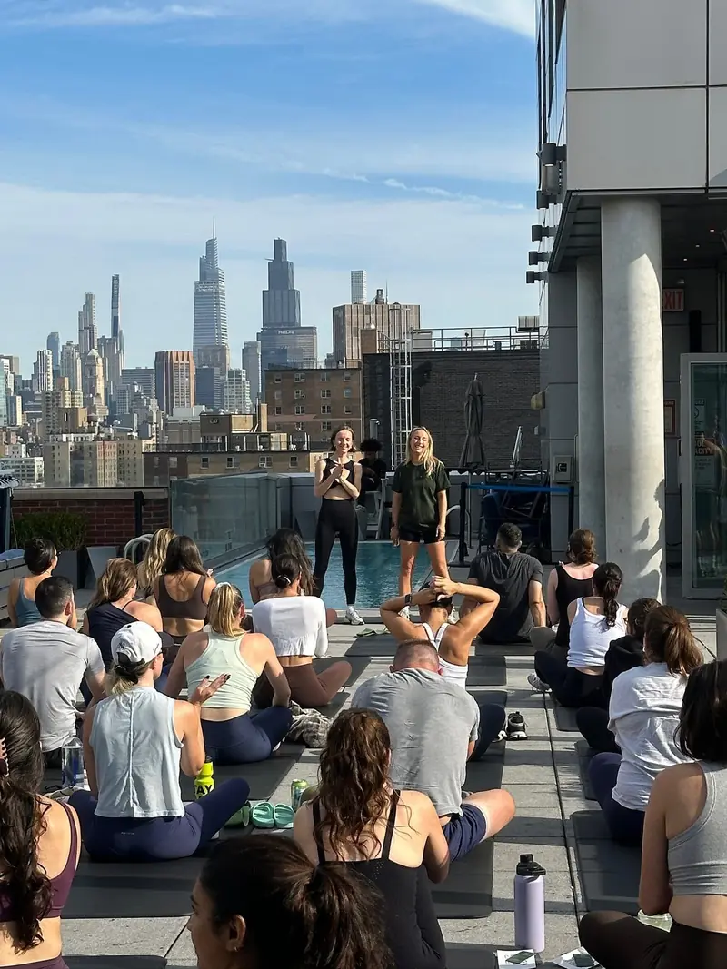 A rooftop movement class in New York with the Manhattan skyline behind