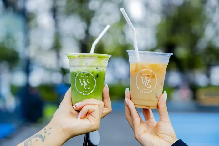 Two Welda Club iced drinks raised in a toast